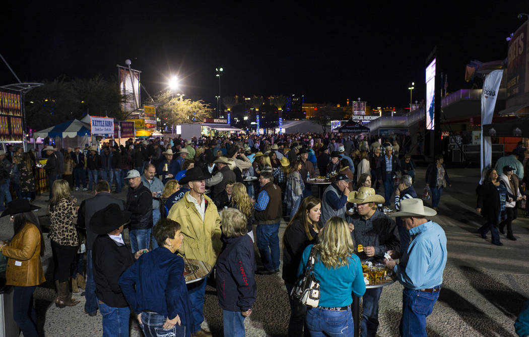 Attendees mingle and eat before the start of the second night of the National Finals Rodeo at the Thomas & Mack Center in Las Vegas on Friday, Dec. 8, 2017. Chase Stevens Las Vegas Review-Jour ...